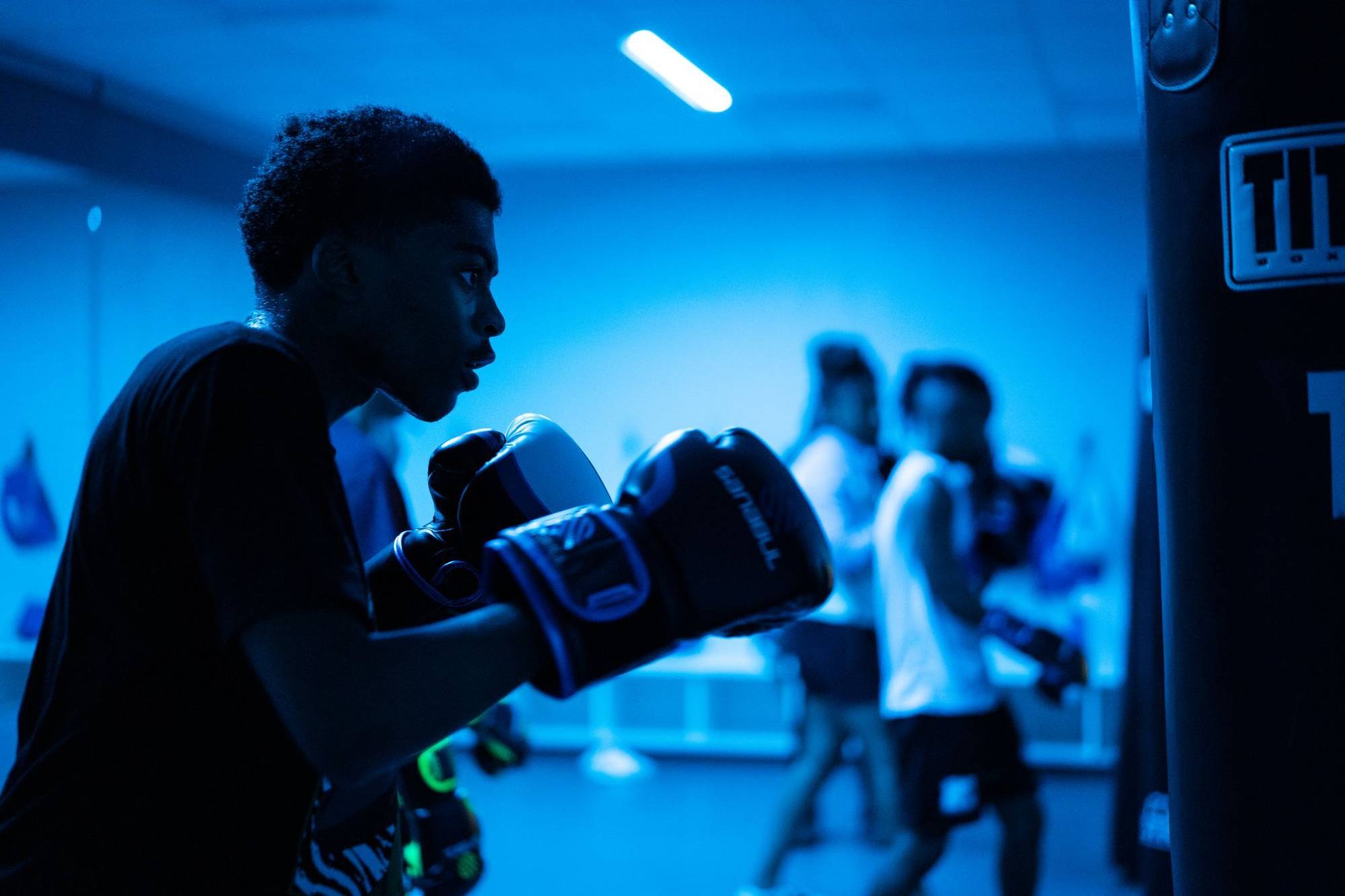 Two boxing gloved stacked on the floor.